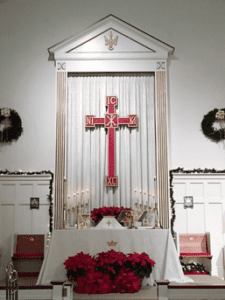 A church with a large cross on the altar.