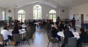 A group of people sitting at tables in a room.