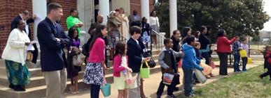 A group of children walking down the steps.