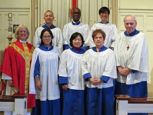 A group of people in white and blue robes.