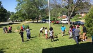 A group of people playing frisbee in the grass.