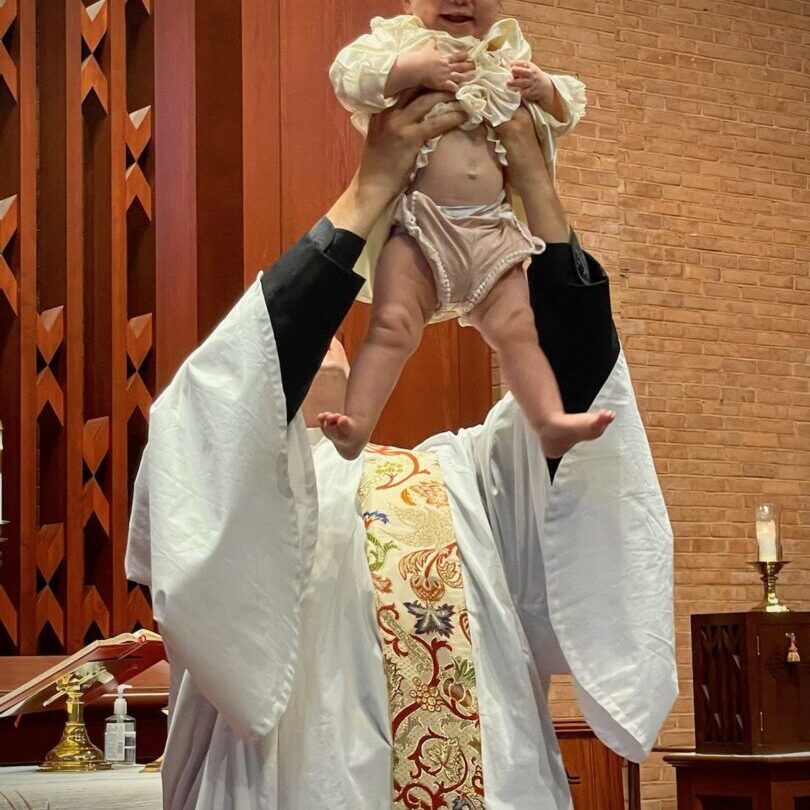 A man holding a baby in the air